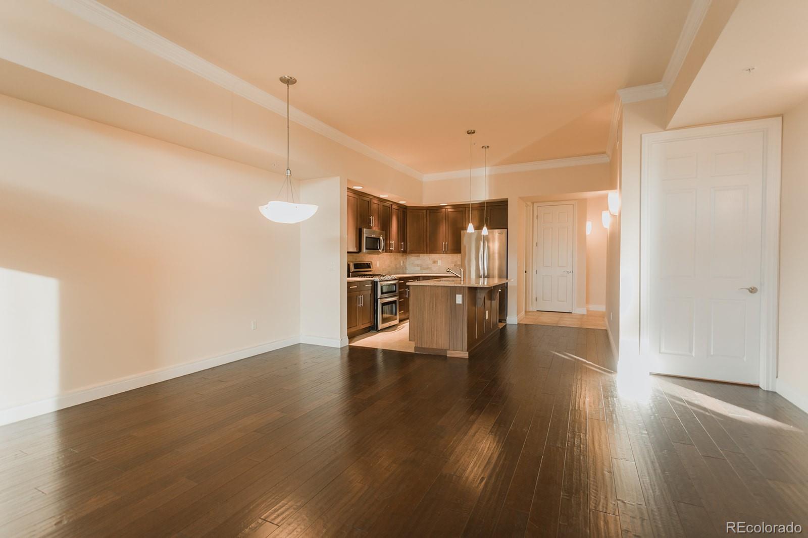 1120 Delaware Street, Unit 201 Denver, CO 80204 - Photo 2 of 25 a view of kitchen with wooden floor