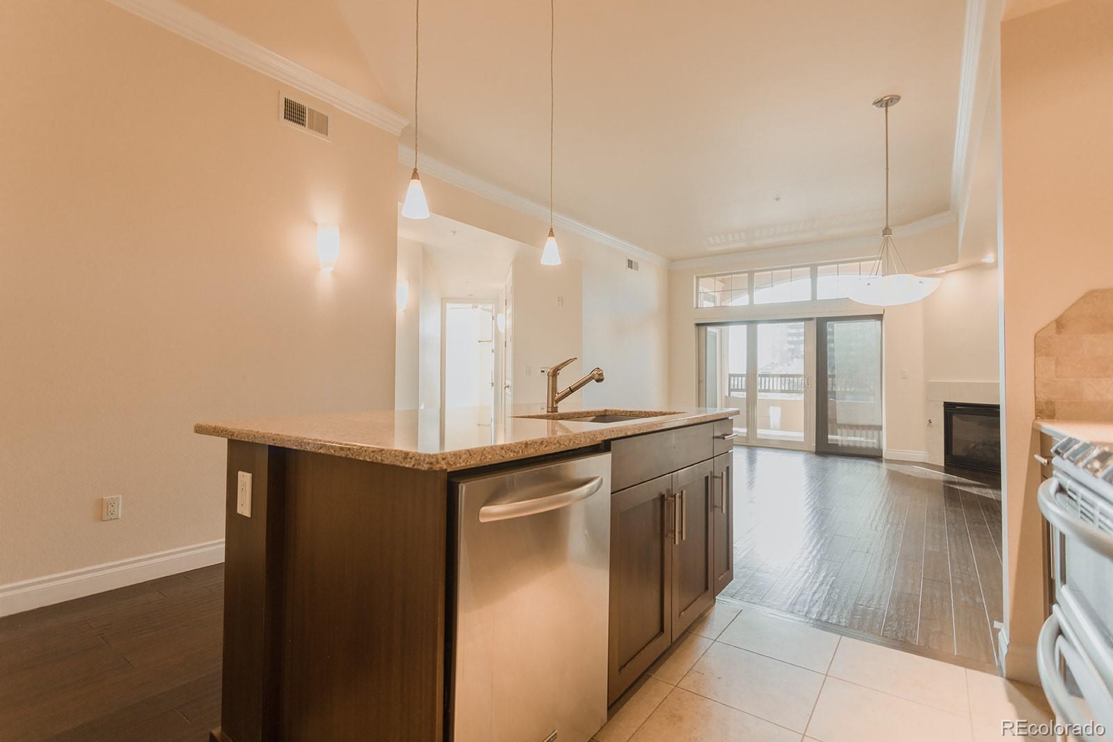 1120 Delaware Street, Unit 201 Denver, CO 80204 - Photo 6 of 25 a kitchen with stainless steel appliances granite countertop a sink and cabinets