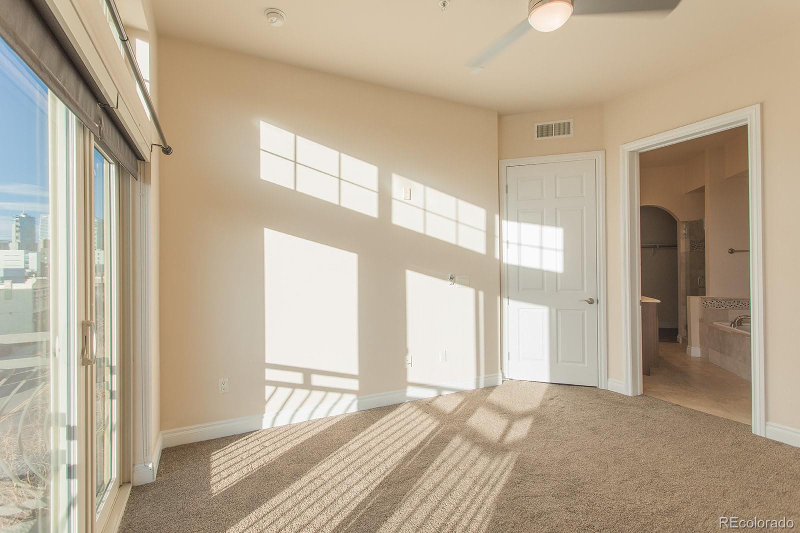 1120 Delaware Street, Unit 201 Denver, CO 80204 - Photo 10 of 25 a view of a livingroom with wooden floor and windows