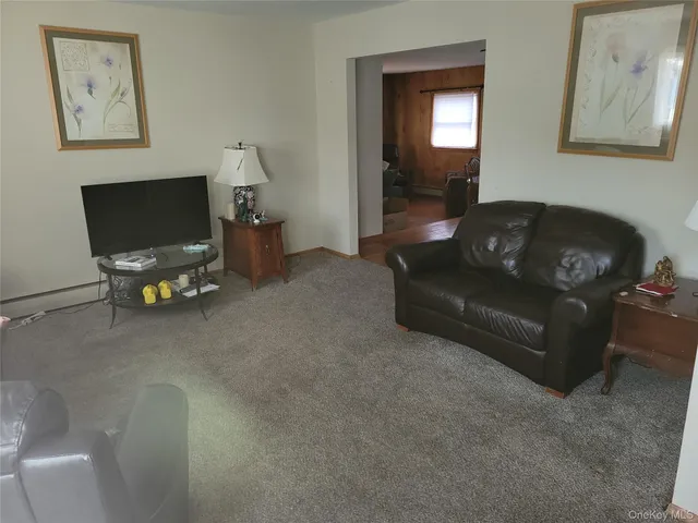 a living room with furniture and a mirror
