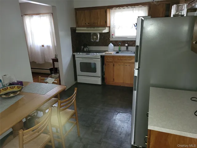 a kitchen with kitchen island a sink stove and refrigerator