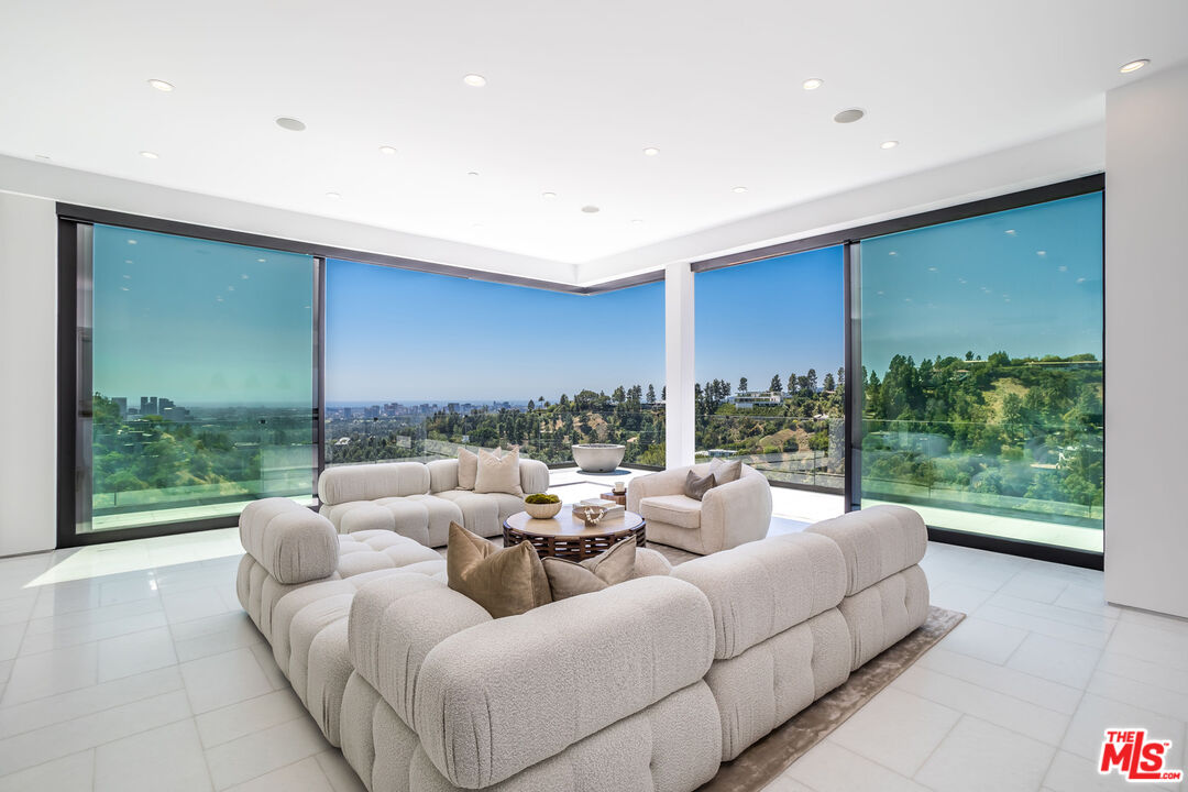 9406 Lloydcrest Drive Beverly Hills, CA 90210 - Photo 14 of 52 a living room with furniture and a large window