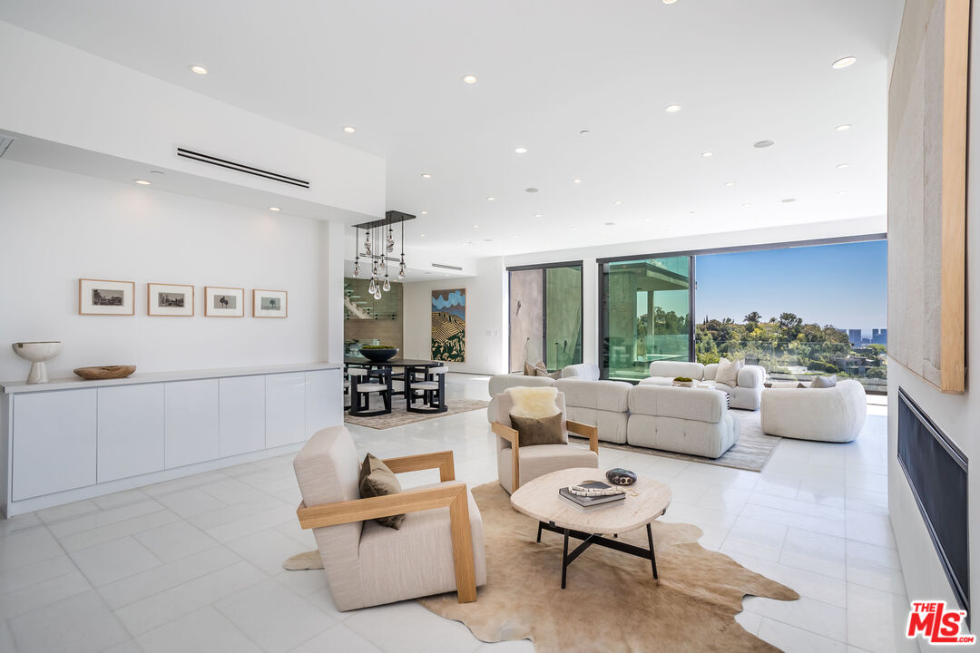 9406 Lloydcrest Drive Beverly Hills, CA 90210 - Photo 16 of 52 a living room with furniture and a table