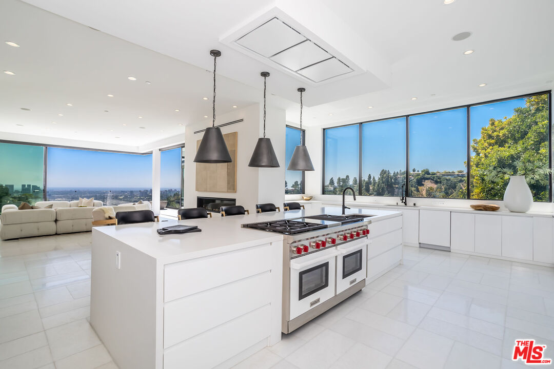 9406 Lloydcrest Drive Beverly Hills, CA 90210 - Photo 18 of 52 a kitchen that has a stove and a sink