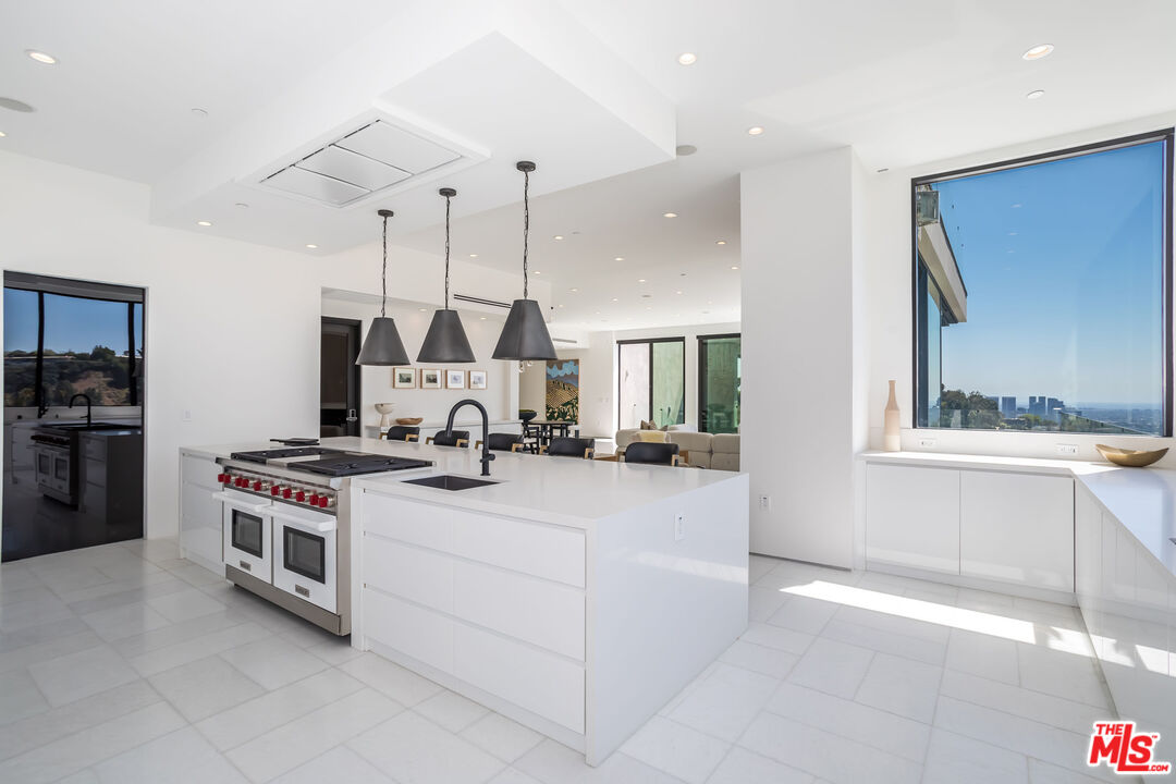 9406 Lloydcrest Drive Beverly Hills, CA 90210 - Photo 19 of 52 a kitchen with a stove and a sink