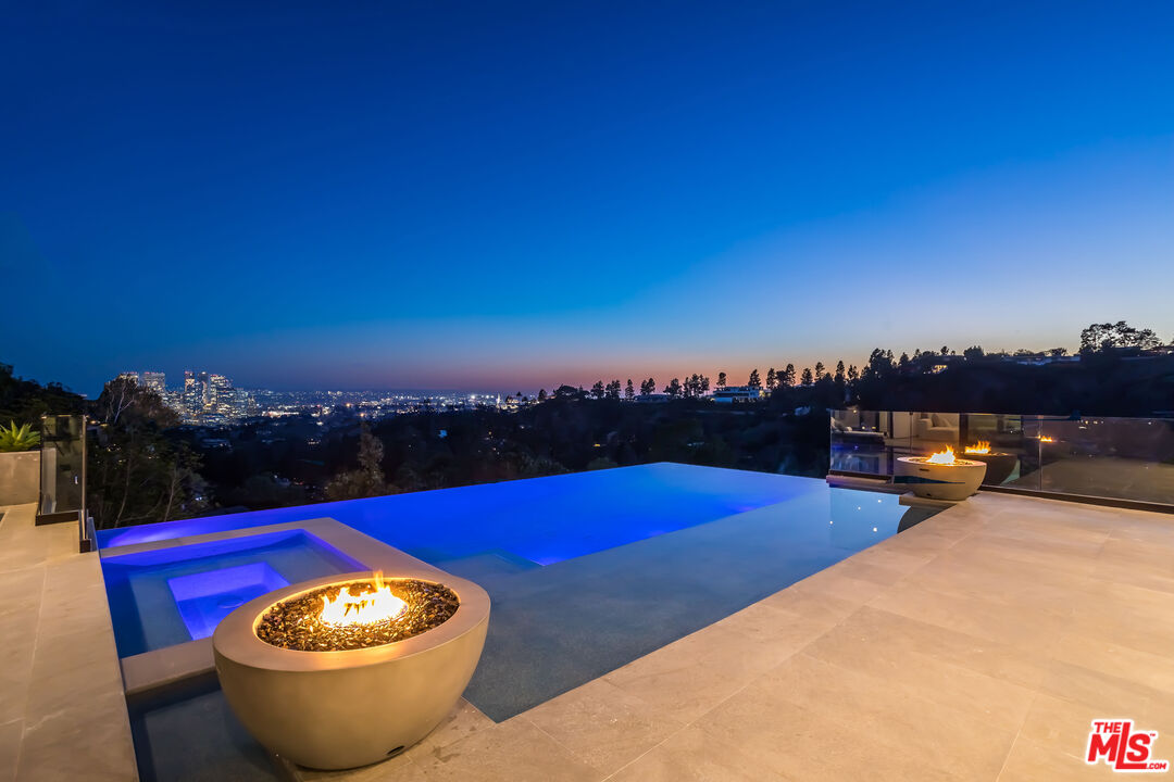 9406 Lloydcrest Drive Beverly Hills, CA 90210 - Photo 3 of 52 a view of swimming pool with outdoor seating and city view