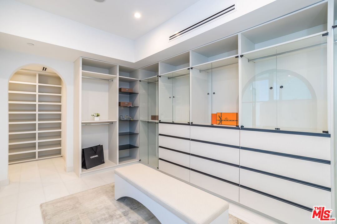 9406 Lloydcrest Drive Beverly Hills, CA 90210 - Photo 35 of 52 a view of an empty walk in closet and a window