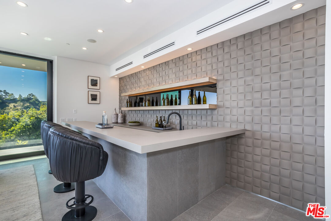 9406 Lloydcrest Drive Beverly Hills, CA 90210 - Photo 40 of 52 a kitchen with a sink a counter space and wooden floor