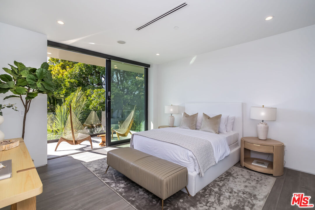 9406 Lloydcrest Drive Beverly Hills, CA 90210 - Photo 45 of 52 a bedroom with a bed and a large window