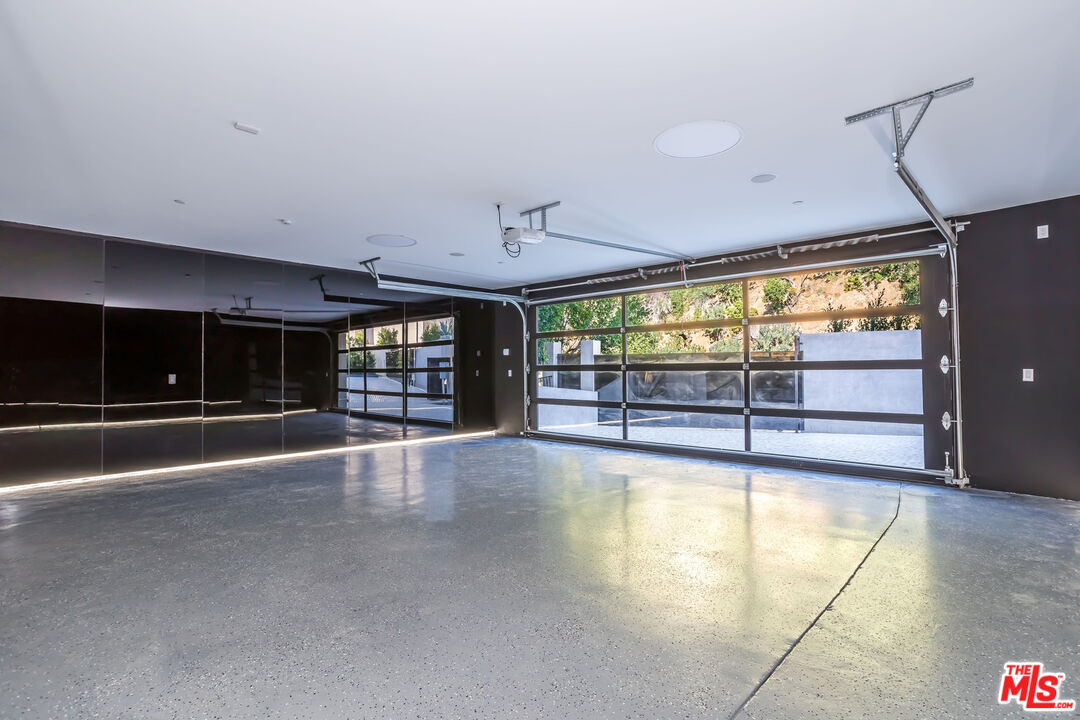 9406 Lloydcrest Drive Beverly Hills, CA 90210 - Photo 48 of 52 a view of an empty room with a fireplace and a large window