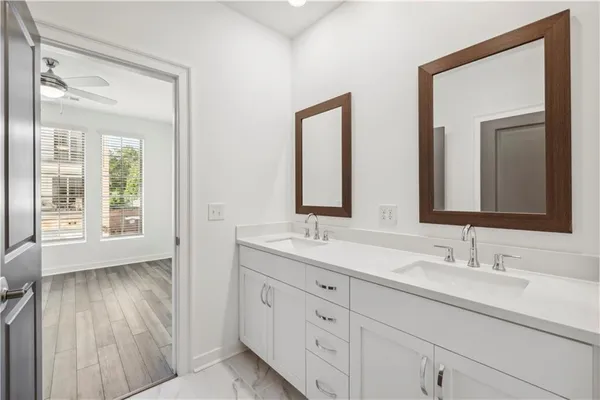 a bathroom with 2 sink and a mirror