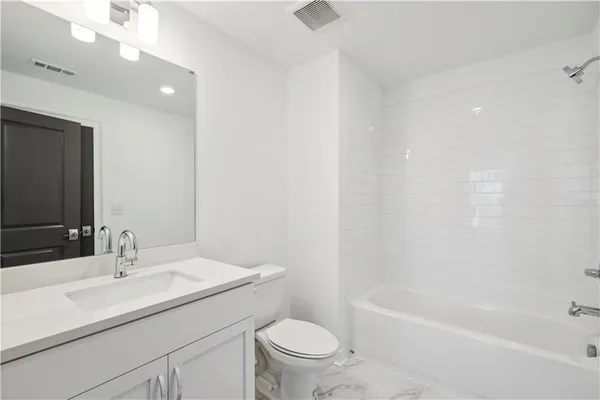 a bathroom with a sink a toilet and a bathtub