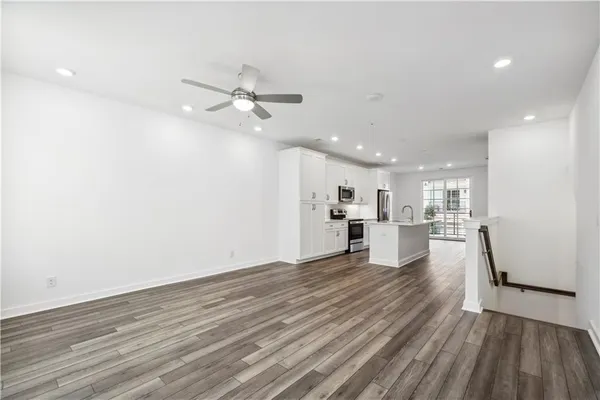 a view of a kitchen with wooden floor and a kitchen counter