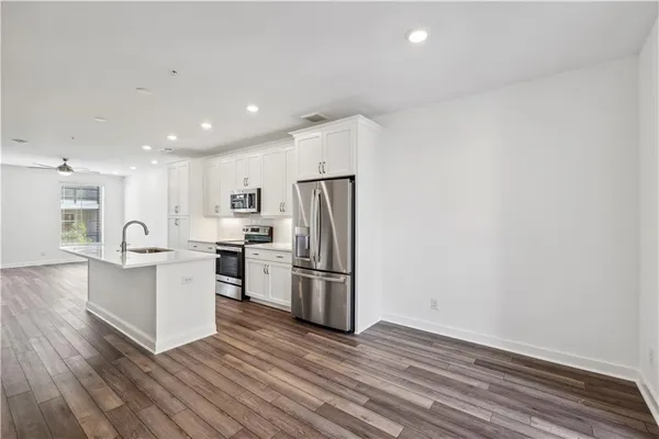 a kitchen with refrigerator and cabinets