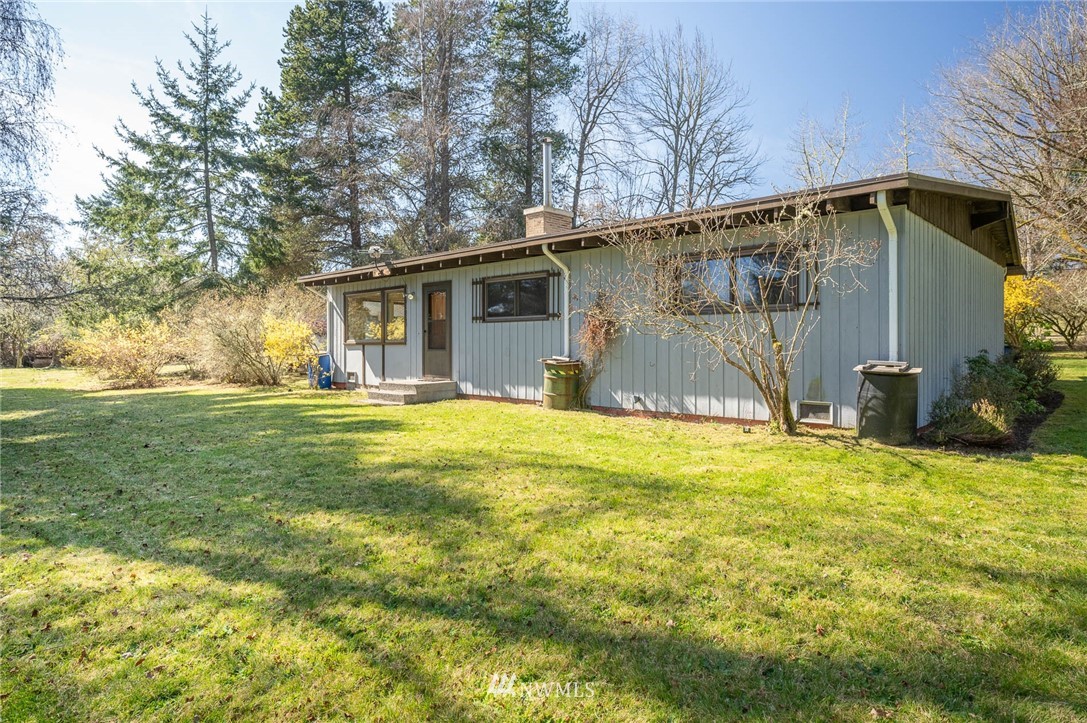 18101 Beall Road Southwest Vashon, WA 98070 - Photo 22 of 37 a backyard of a house with yard and barbeque oven
