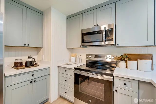 a kitchen with cabinets stainless steel appliances and a sink