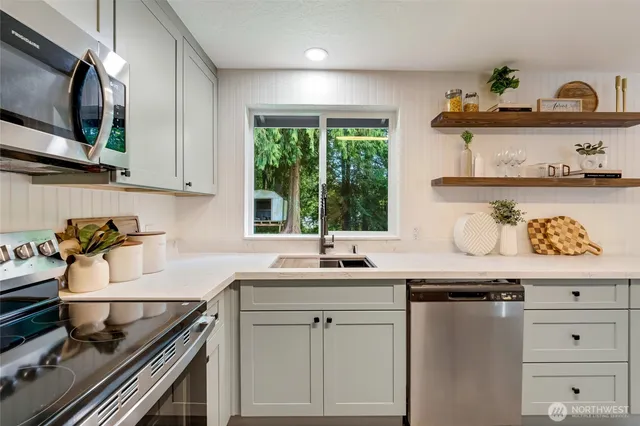 a kitchen with granite countertop a sink and wooden cabinets
