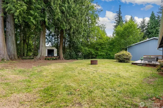 a swimming pool with outdoor seating and yard