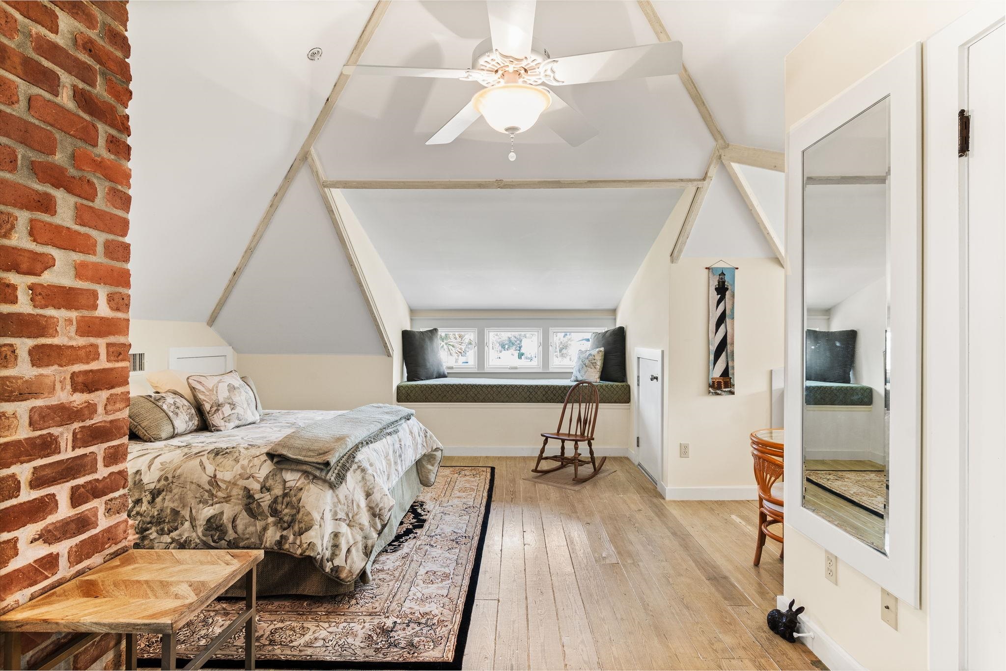 178 Avenida Menendez St. Augustine, FL 32084 - Photo 31 of 42 a bedroom with a bed and a chandelier