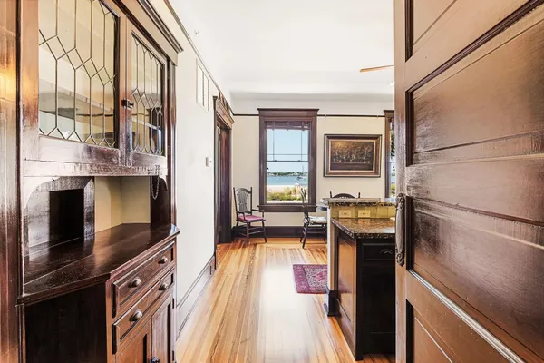 a kitchen with stainless steel appliances granite countertop a refrigerator a stove and a sink with wooden floor