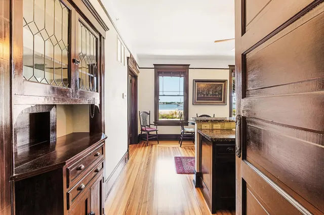 a kitchen with stainless steel appliances granite countertop a refrigerator a stove and a sink with wooden floor