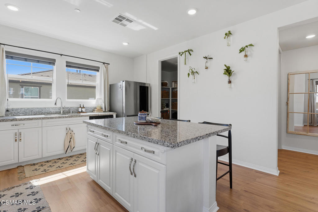 512 Mulberry Lane Fillmore, CA 93015 - Photo 11 of 54 a kitchen with stainless steel appliances granite countertop a sink and dishwasher with wooden floor