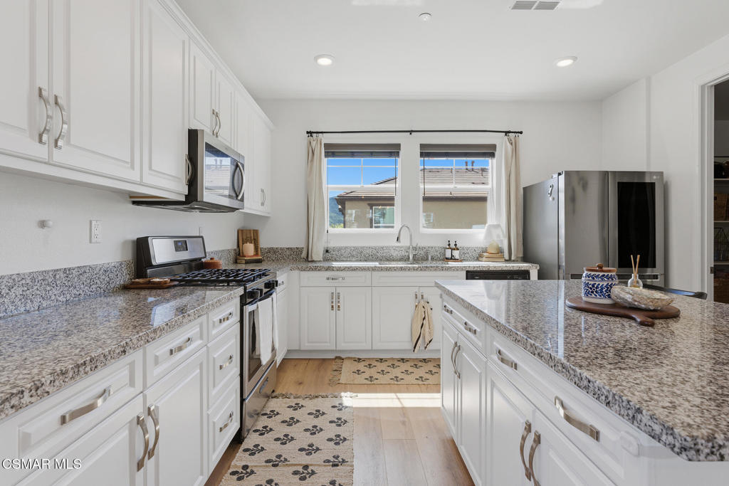512 Mulberry Lane Fillmore, CA 93015 - Photo 12 of 54 a kitchen with stainless steel appliances granite countertop a sink stove and refrigerator