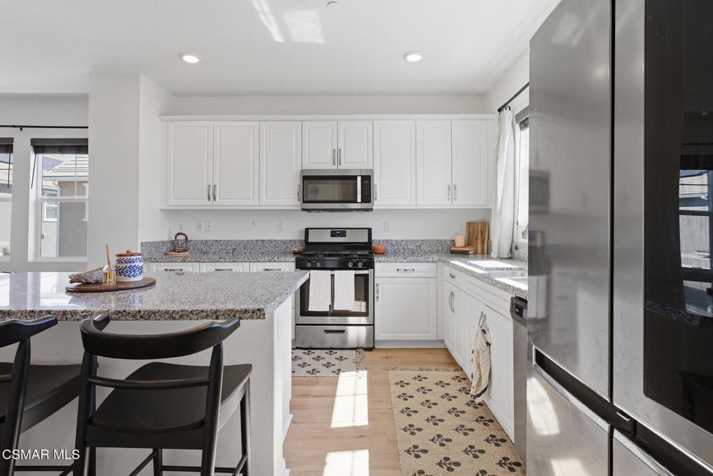 512 Mulberry Lane Fillmore, CA 93015 - Photo 15 of 54 a kitchen with granite countertop a sink stove and refrigerator
