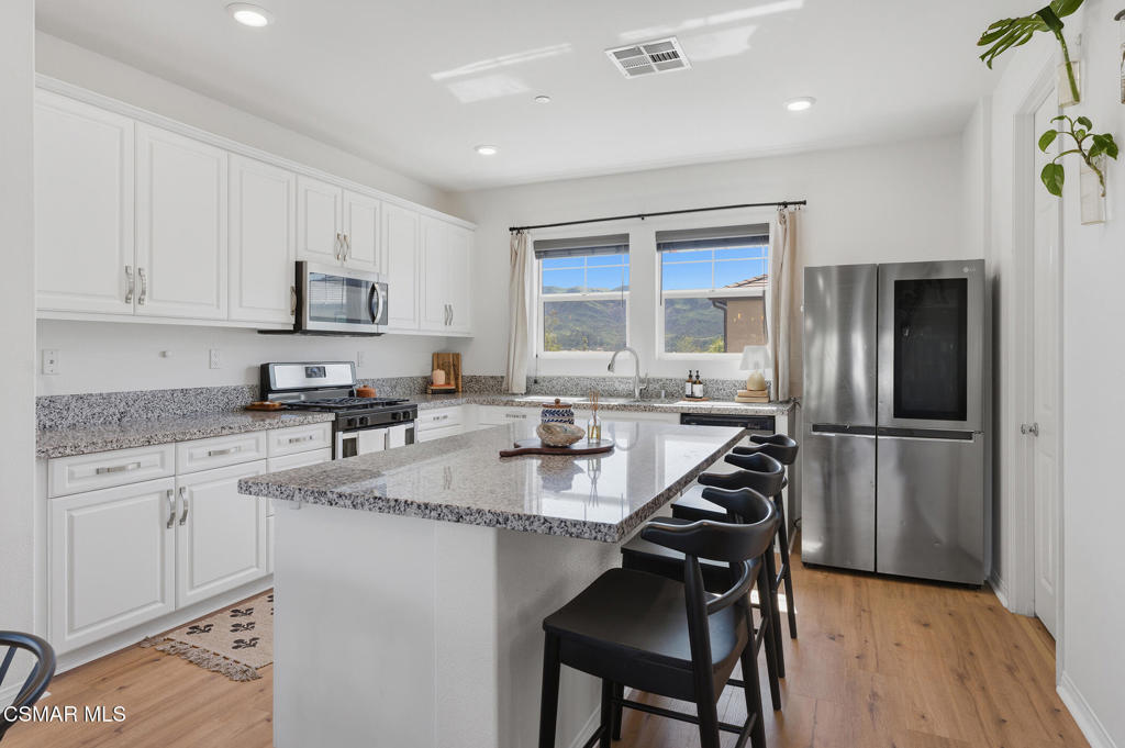 512 Mulberry Lane Fillmore, CA 93015 - Photo 6 of 54 a kitchen with refrigerator cabinets and large window
