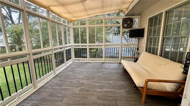 a view of a balcony with chair and wooden floor