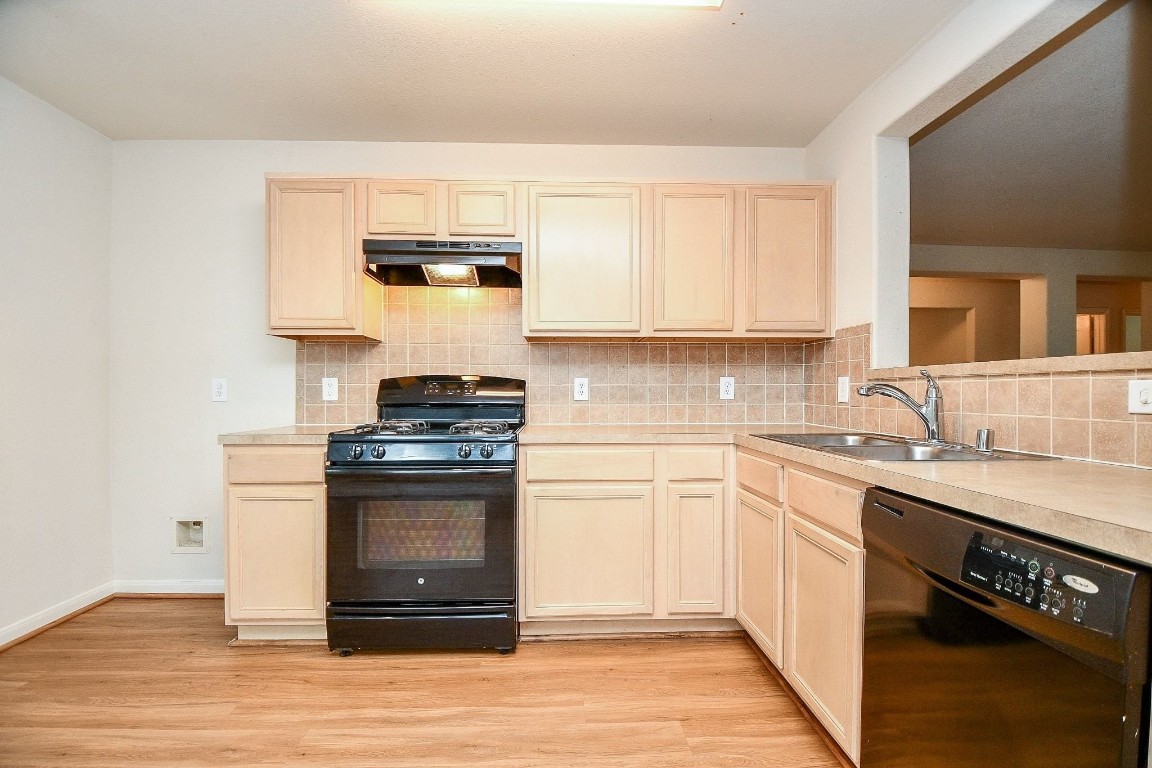 29530 Legends Glen Drive Spring, TX 77386 - Photo 12 of 50 a kitchen with stainless steel appliances a stove and white cabinets