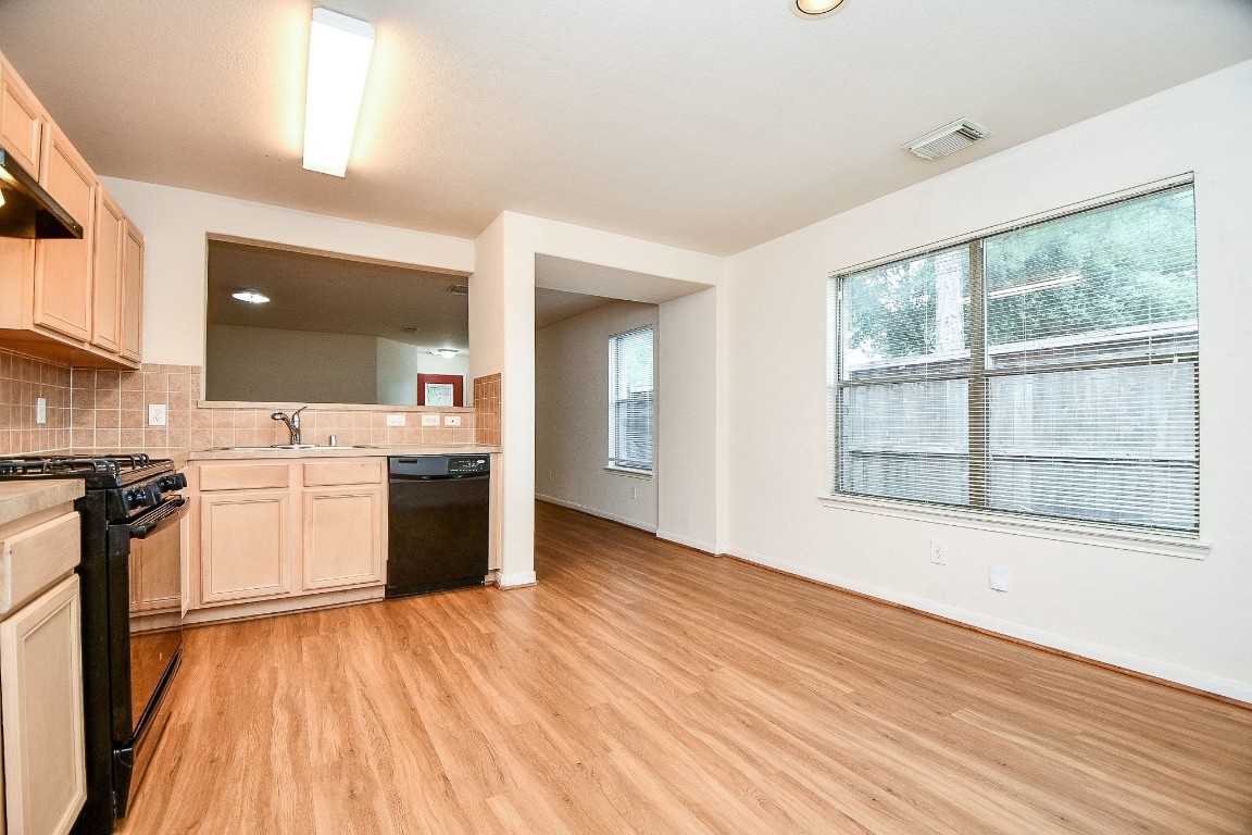 29530 Legends Glen Drive Spring, TX 77386 - Photo 15 of 50 a view of a kitchen with a sink wooden floor and a large window