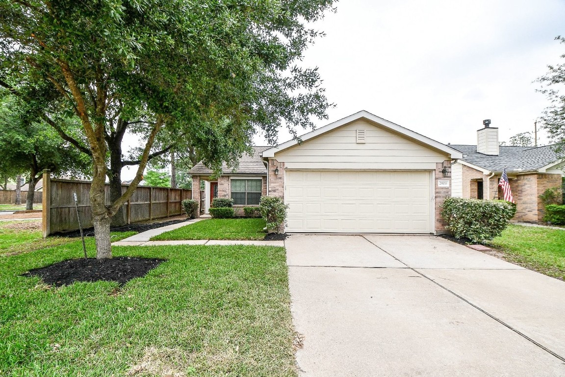 29530 Legends Glen Drive Spring, TX 77386 - Photo 2 of 50 a front view of a house with a yard and trees