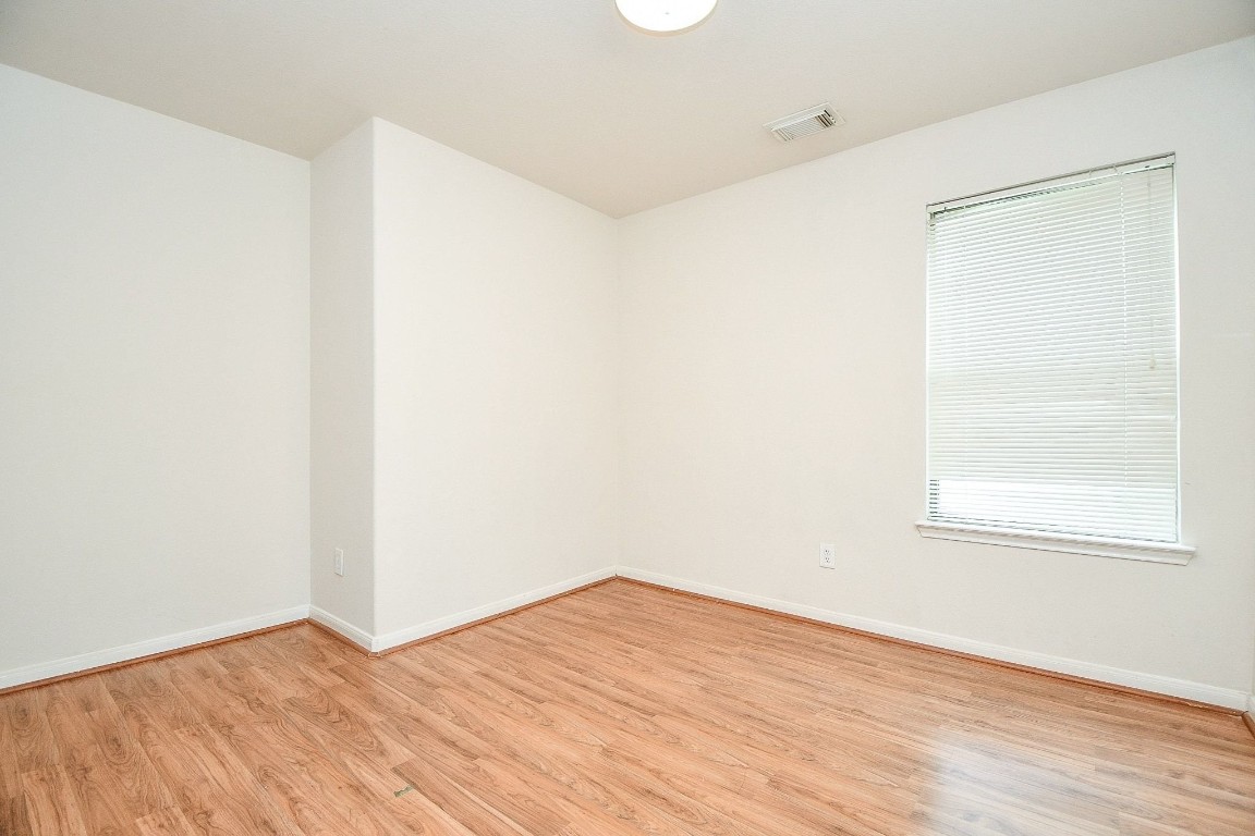 29530 Legends Glen Drive Spring, TX 77386 - Photo 23 of 50 an empty room with wooden floor and windows