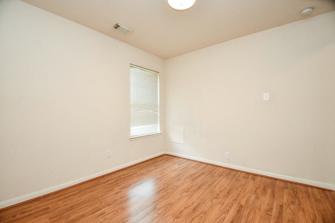 29530 Legends Glen Drive Spring, TX 77386 - Photo 24 of 50 an empty room with wooden floor and windows