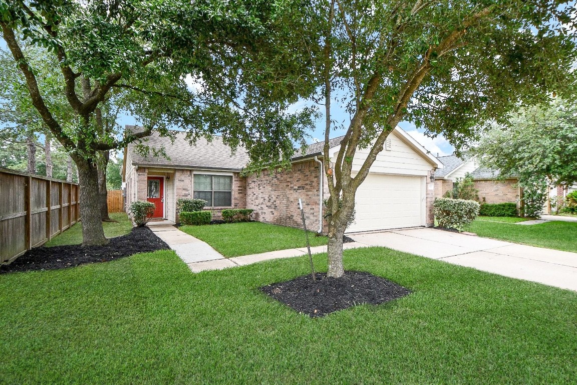 29530 Legends Glen Drive Spring, TX 77386 - Photo 3 of 50 a front view of a house with a yard and garage