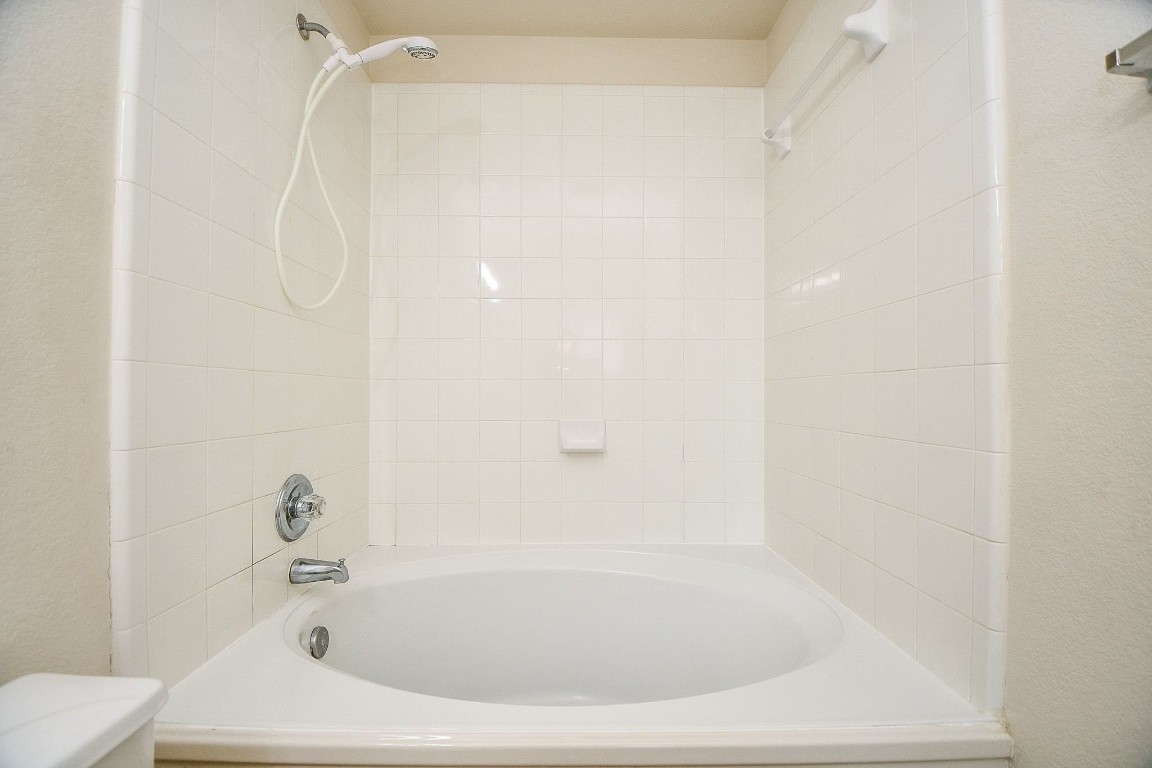 29530 Legends Glen Drive Spring, TX 77386 - Photo 33 of 50 a white bath tub sitting next to a white toilet