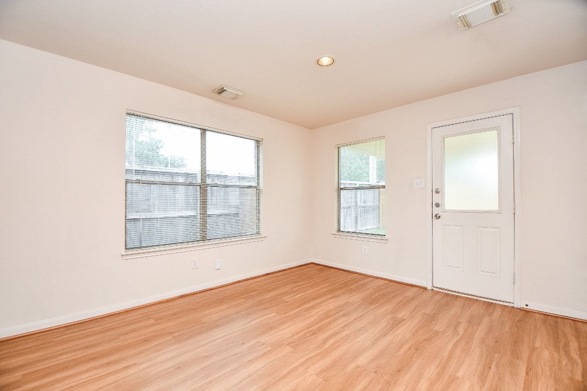 29530 Legends Glen Drive Spring, TX 77386 - Photo 40 of 50 an empty room with wooden floor and windows