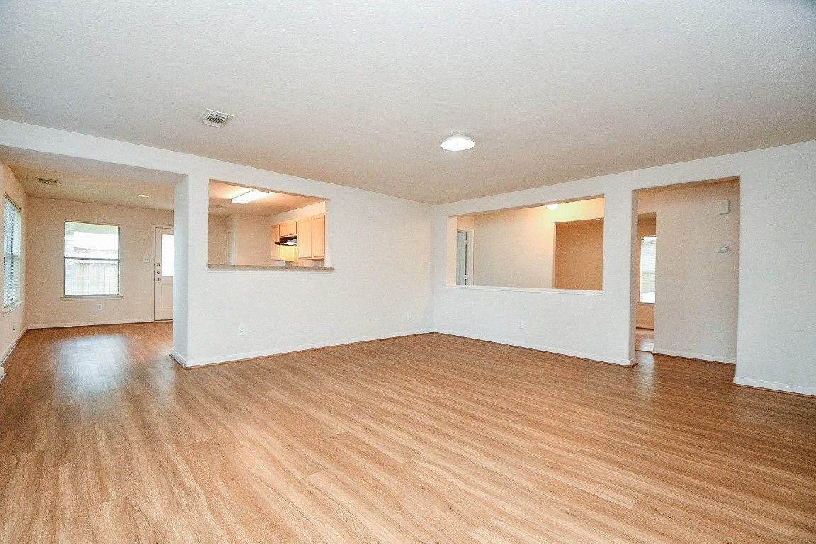 29530 Legends Glen Drive Spring, TX 77386 - Photo 7 of 50 a view of an empty room with wooden floor and a window