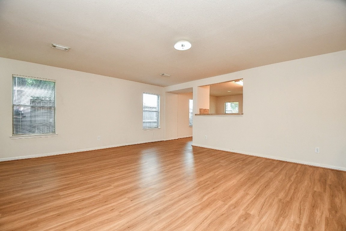29530 Legends Glen Drive Spring, TX 77386 - Photo 8 of 50 an empty room with wooden floor and windows