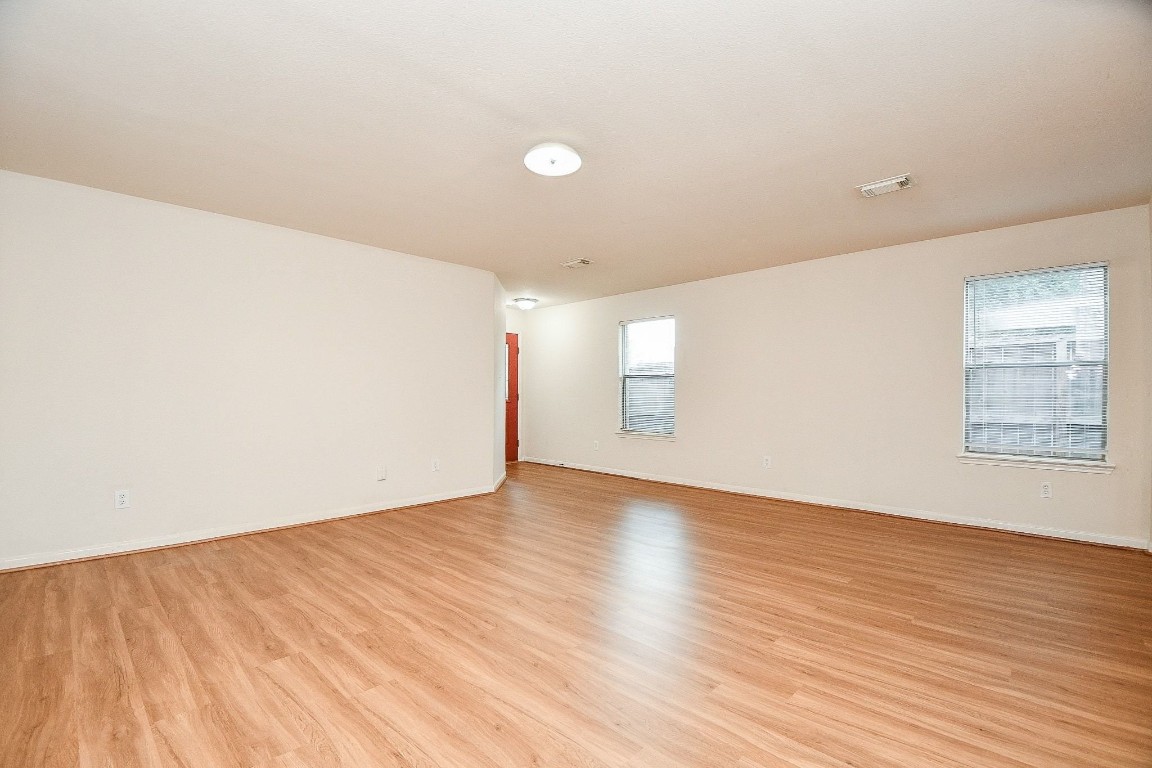 29530 Legends Glen Drive Spring, TX 77386 - Photo 9 of 50 an empty room with wooden floor and windows