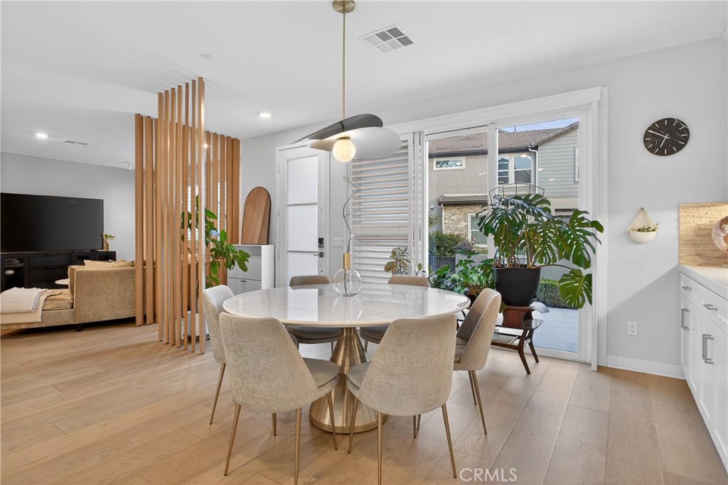 382 Chorus Irvine, CA 92618 - Photo 6 of 38 a view of a dining room with furniture window and wooden floor