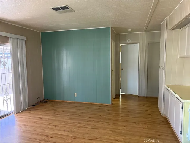 a view of room with window and wooden floor