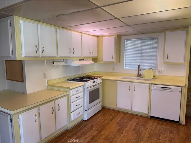a kitchen with sink a stove and cabinets