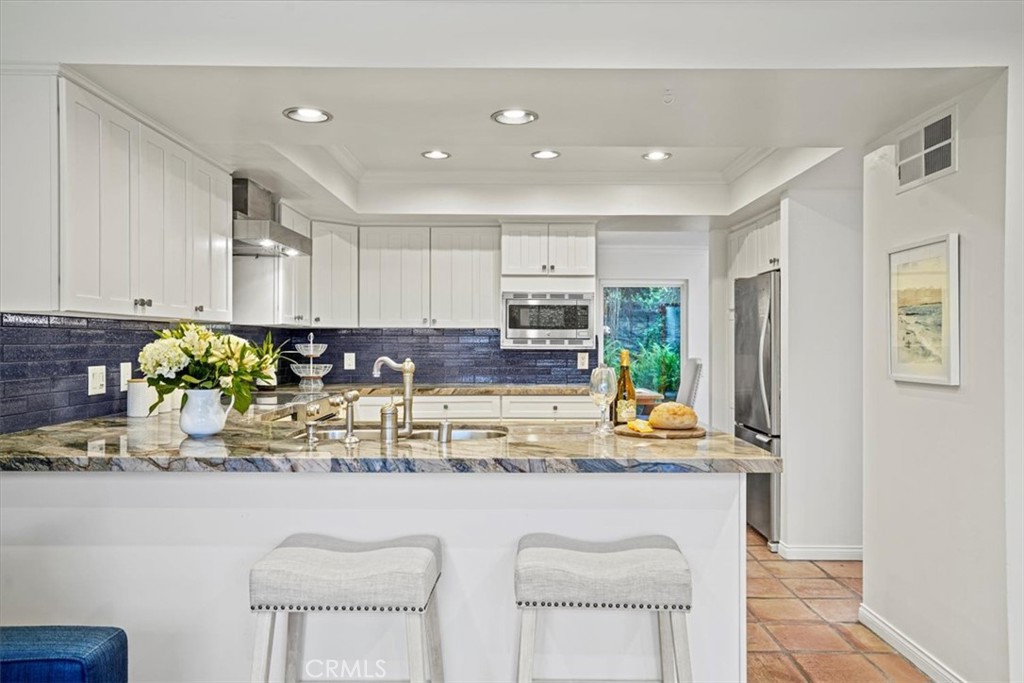 23802 Cassandra Bay Dana Point, CA 92629 - Photo 12 of 56 a kitchen with stainless steel appliances granite countertop a refrigerator and a stove top oven