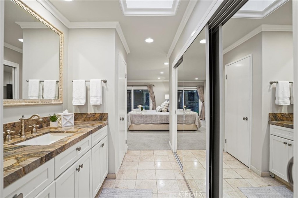 23802 Cassandra Bay Dana Point, CA 92629 - Photo 34 of 56 a bathroom with a double vanity sink and mirror