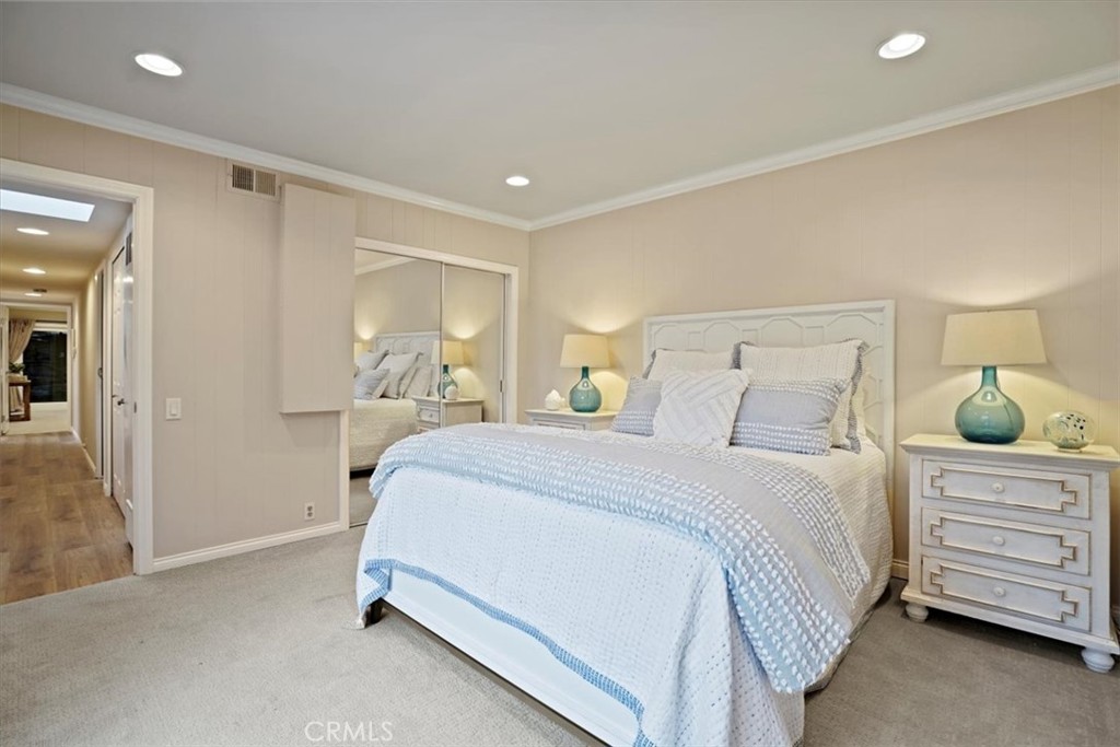 23802 Cassandra Bay Dana Point, CA 92629 - Photo 47 of 56 a bedroom with a bed a lamp and mirror