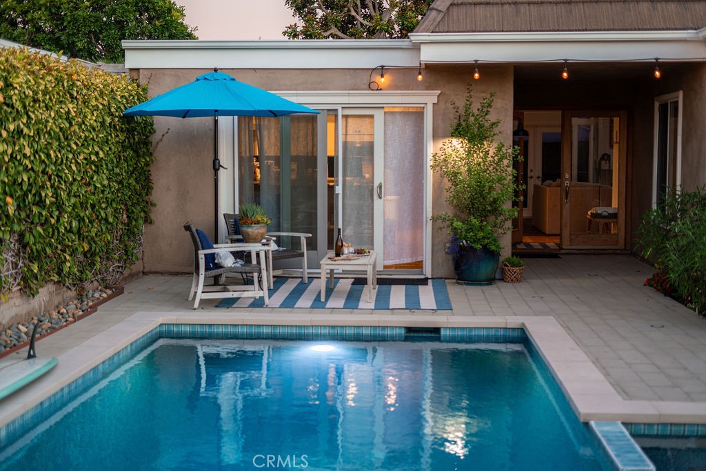 23802 Cassandra Bay Dana Point, CA 92629 - Photo 51 of 56 a small pool with table and chairs under an umbrella