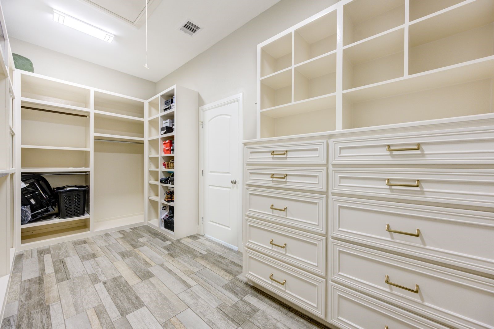21038 Angus Drive Cleveland, TX 77328 - Photo 26 of 49 a view of walk in closet with clothes and shoes