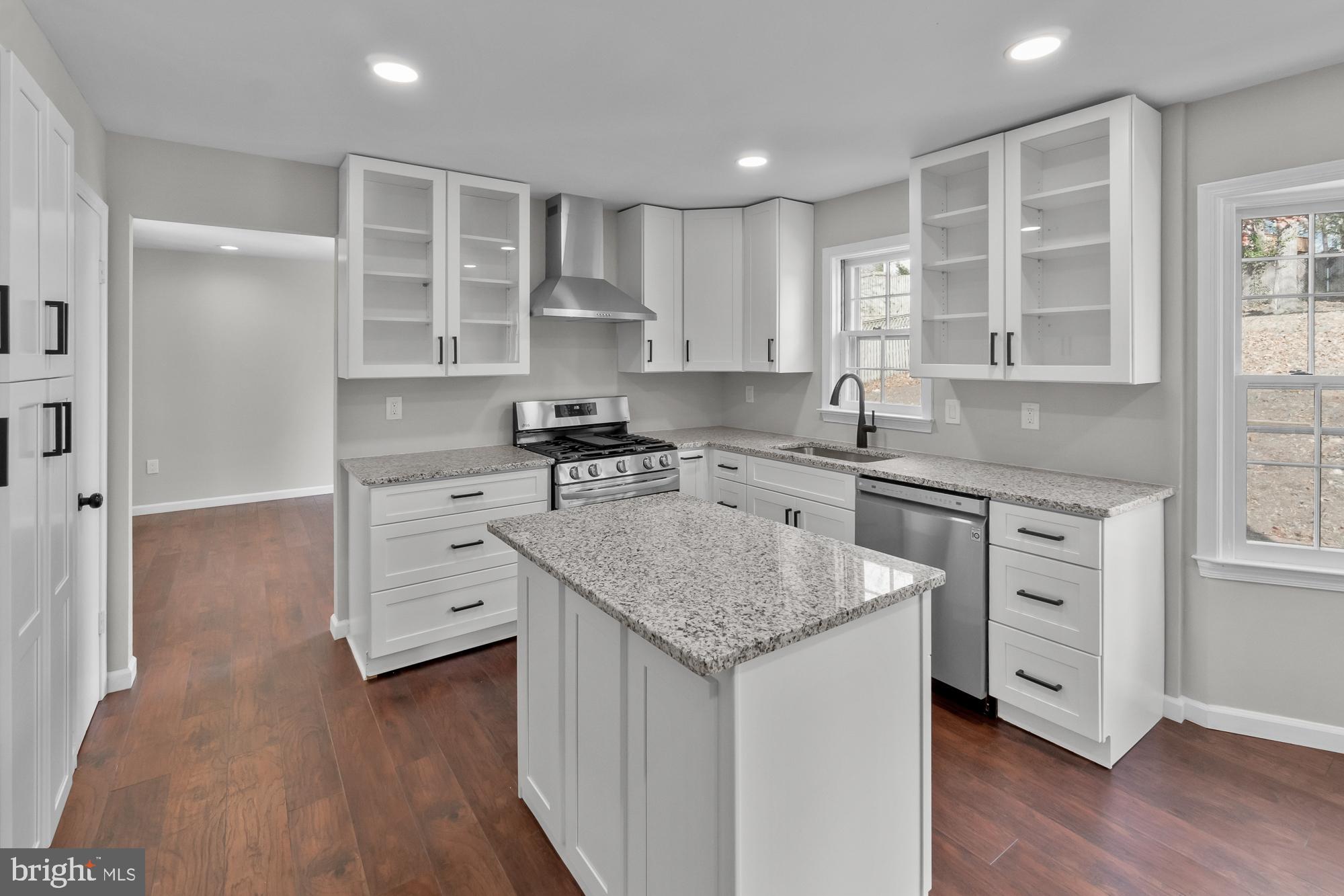 12539 Heurich Road Silver Spring, MD 20902 - Photo 8 of 46 a kitchen with stainless steel appliances granite countertop a sink stove and refrigerator